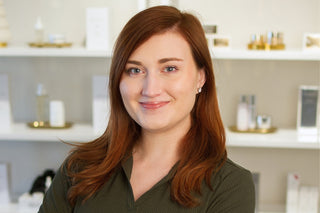 Philly Esthetician, Brook standing inside Skin Devotee Facial Studio with blurred retail background