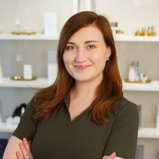 Philly Esthetician, Brook standing inside Skin Devotee Facial Studio with blurred retail background