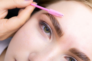 A brow sculpting service is being performed on a woman's eyebrows to help shape them to perfection.