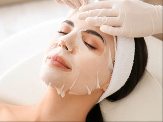 Woman receiving a luxury sheet mask during a facial at Skin Devotee Facial Studio