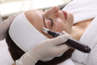 Woman receiving a microchanneling treatment with device