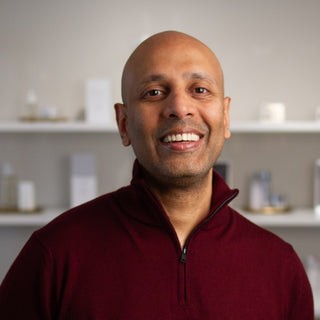 Spa Director, Neil standing inside Skin Devotee Facial Studio with blurred retail background