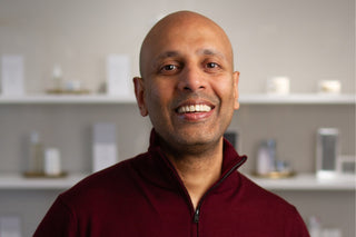 Spa Director, Neil standing inside Skin Devotee Facial Studio with blurred retail background