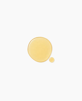 Golden cleansing oil texture of the OxygenCeuticals Double Makeup Remover on a white background.