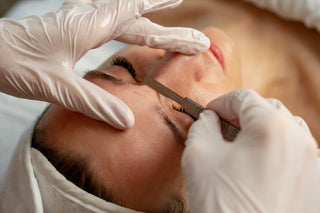 Woman receiving a dermaplaning treatment at Skin Devotee Facial Studio in Philadelphia